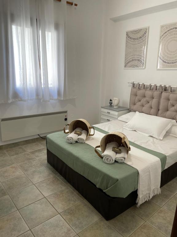 a bedroom with a large bed with towels on it at Melivia apartments in Ierissos