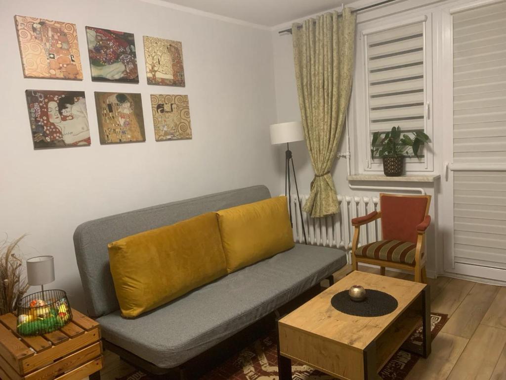 a living room with a couch and a table at Apartament Gustav in Zawiercie