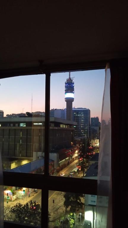 a view from a window of a city with a tower at Departamentos Santiago Centro # 1005 in Santiago