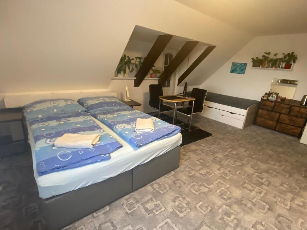 a bedroom with a large bed and a desk at Homestay U Hanky in Zdiby