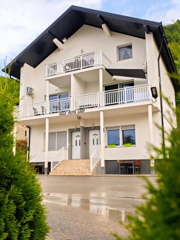 a large white building with a balcony at Villa Pliva Lake 2 in Jajce