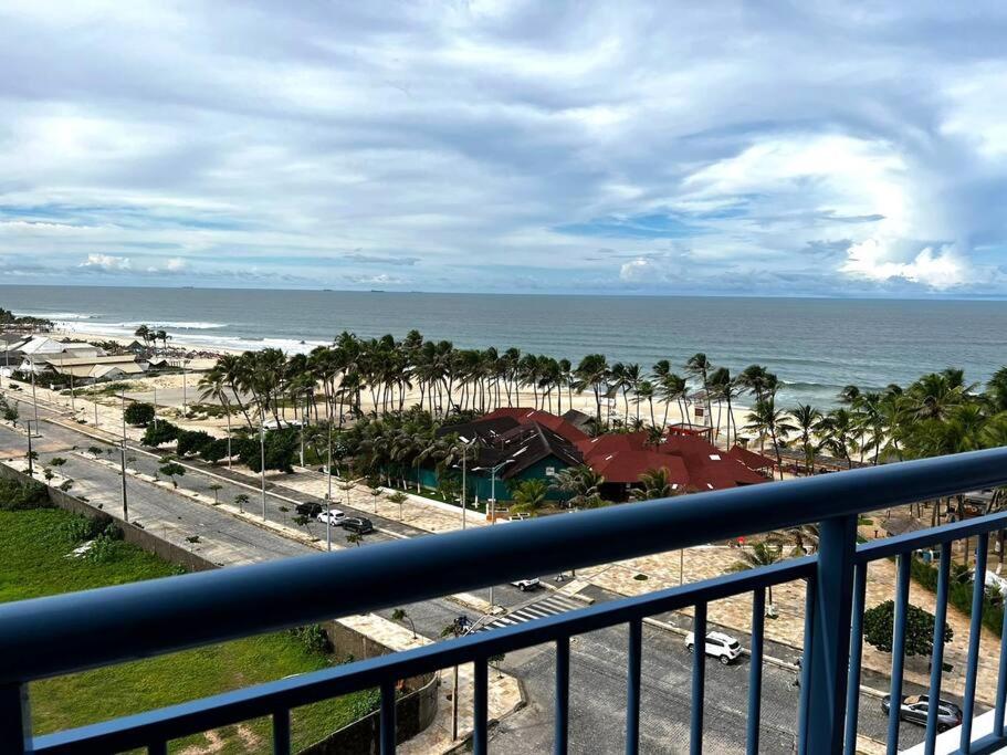 a view of the beach and the ocean from a balcony at Apartamento aconchegante de frente para a praia in Fortaleza