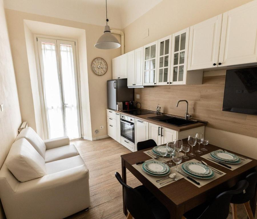 a kitchen with a dining table and a living room at La casa di Gazi in Florence