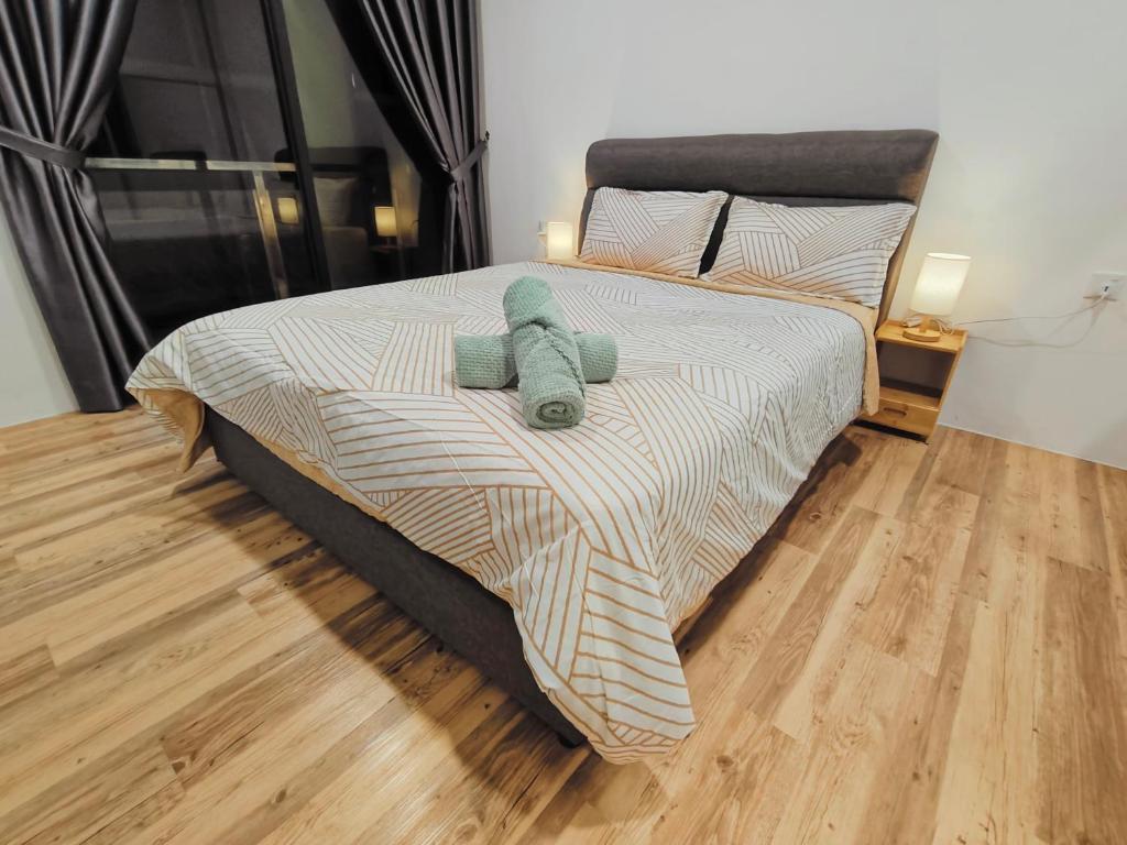 a bed with a teddy bear on top of it at SoulHealingPlace Galacity 2BR 2Bed Apartment in Kuching