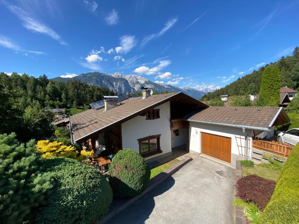 an aerial view of a house with mountains in the background at Ferienhaus Schaiter - Ganzes Haus mit Garten und gratis Parkplatz in Innsbruck