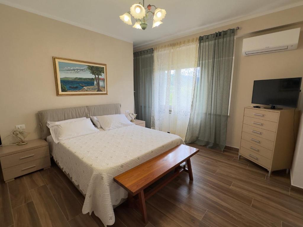a bedroom with a bed and a television in it at I Due Ulivi in Calice al Cornoviglio