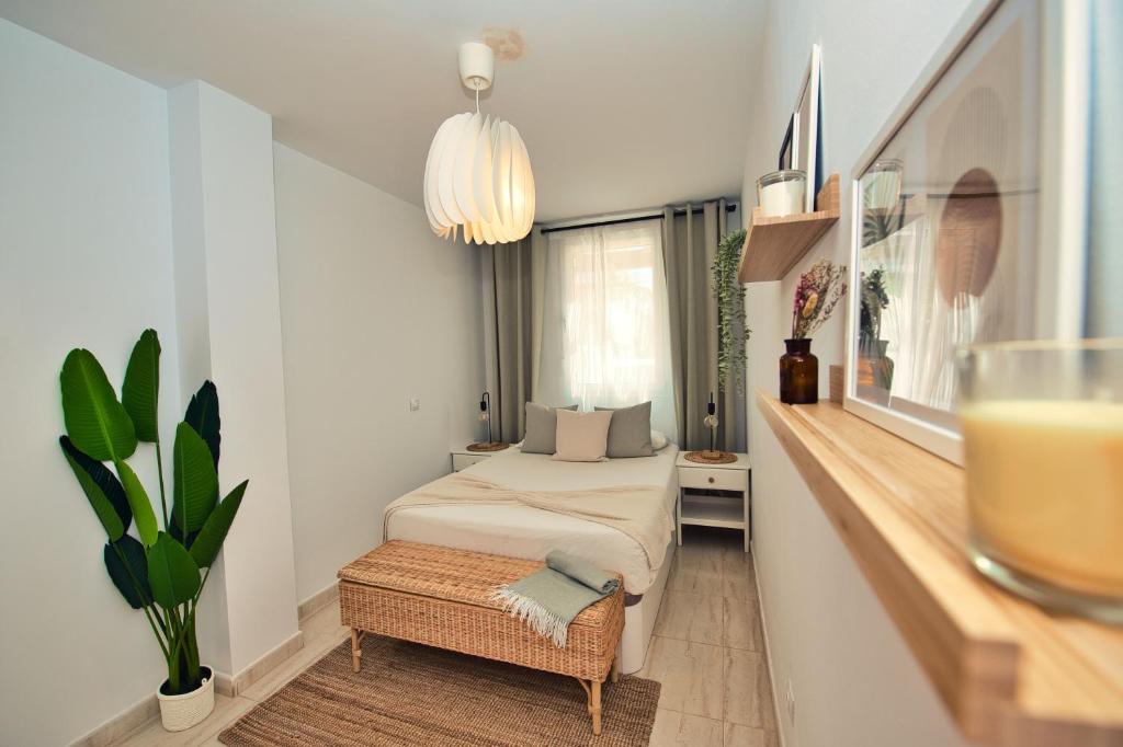 a small room with a bed and a table at Ocean view perfect sunset apartment, 4 rooms 137m2, WiFi & BBQ in San Miguel de Abona