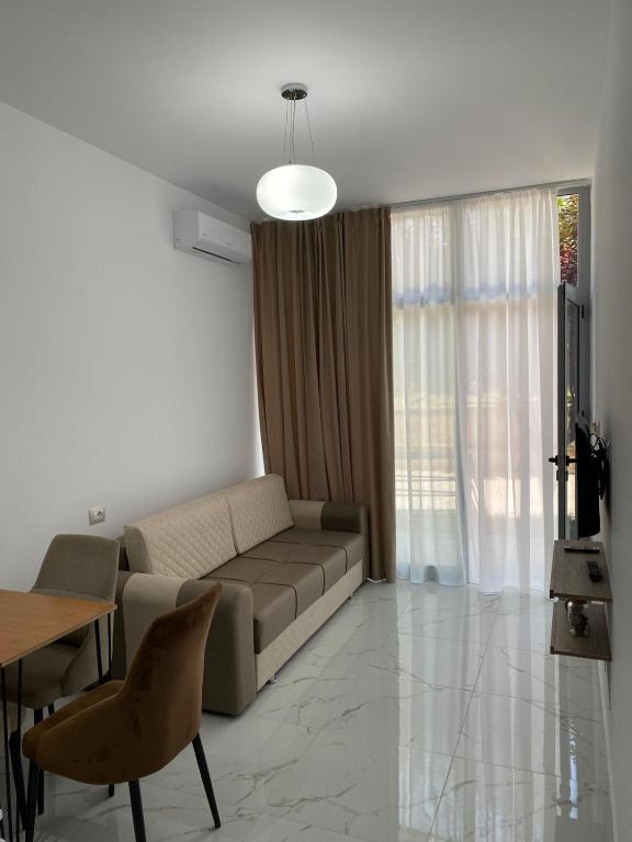 a living room with a couch and a table at Pogradeci Apartments in Pogradec
