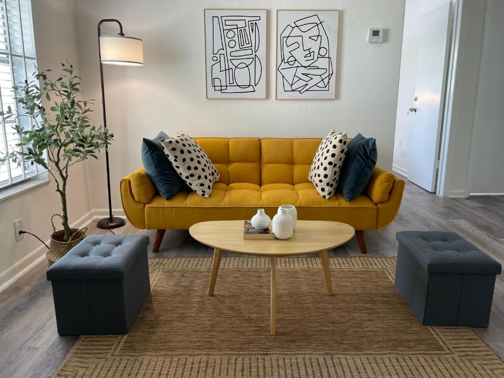 Hotel Remodeled Little Havanna Apartments great location, a living room with a yellow couch and a table at Remodeled Little Havanna Apartments great location in Miami