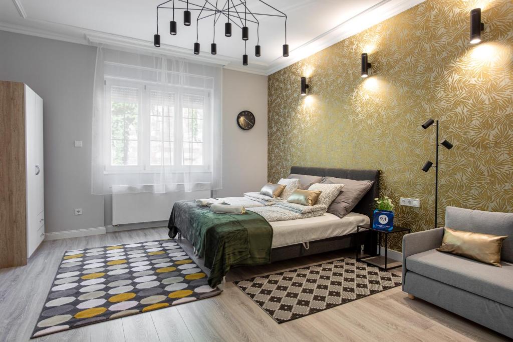 a bedroom with a bed and a couch at Buda Castle Serpentine Apartments in Budapest