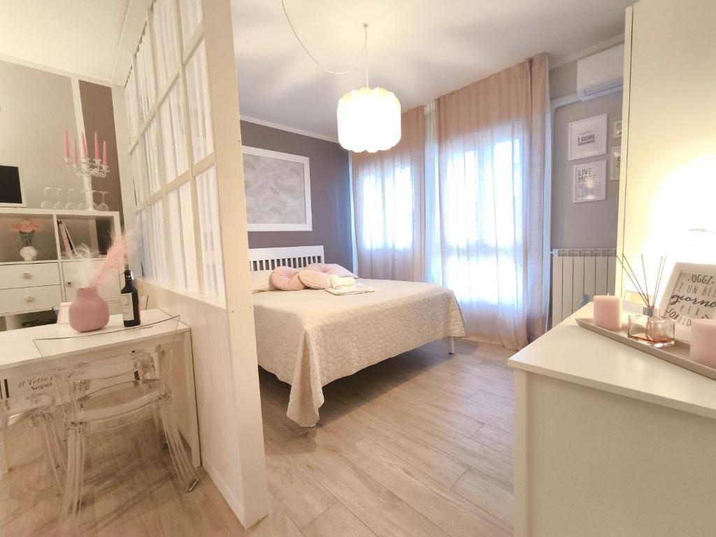 a bedroom with a bed and a table in a room at Il Tetto dei Sogni in Pistoia