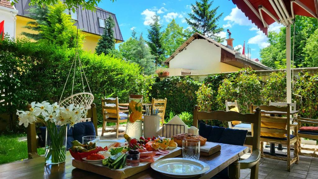 a table with food on it on a patio at Grand Boutique Hotel in Prishtinë