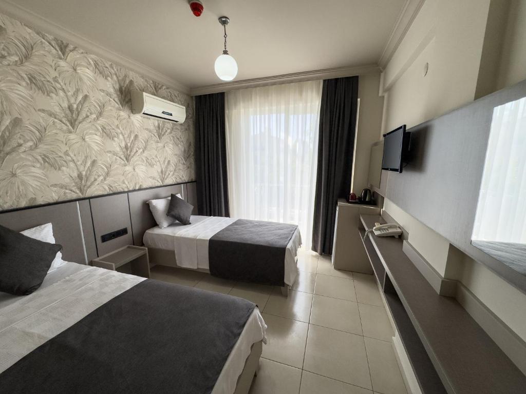 Postel nebo postele na pokoji v ubytování Sardunya Hotel