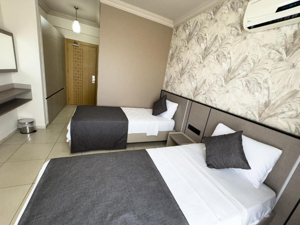 Postel nebo postele na pokoji v ubytování Sardunya Hotel