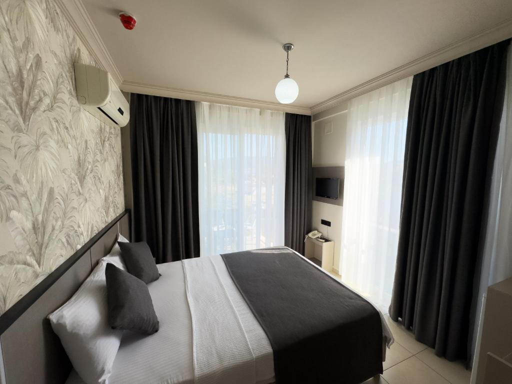 Postel nebo postele na pokoji v ubytování Sardunya Hotel