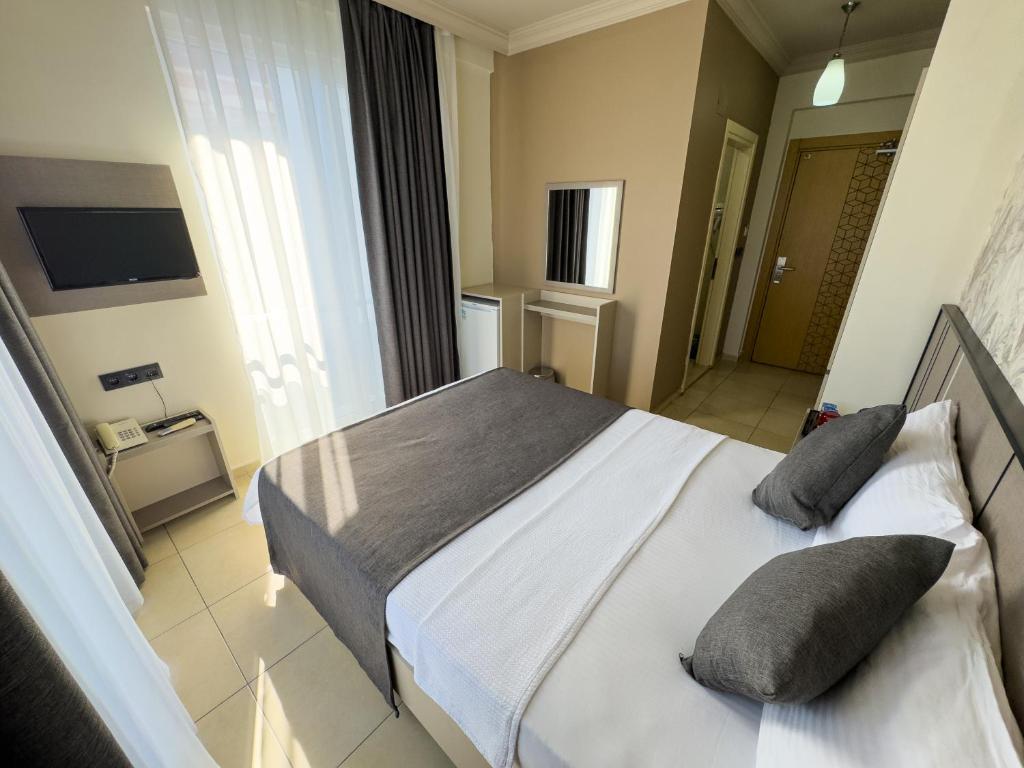 Postel nebo postele na pokoji v ubytování Sardunya Hotel