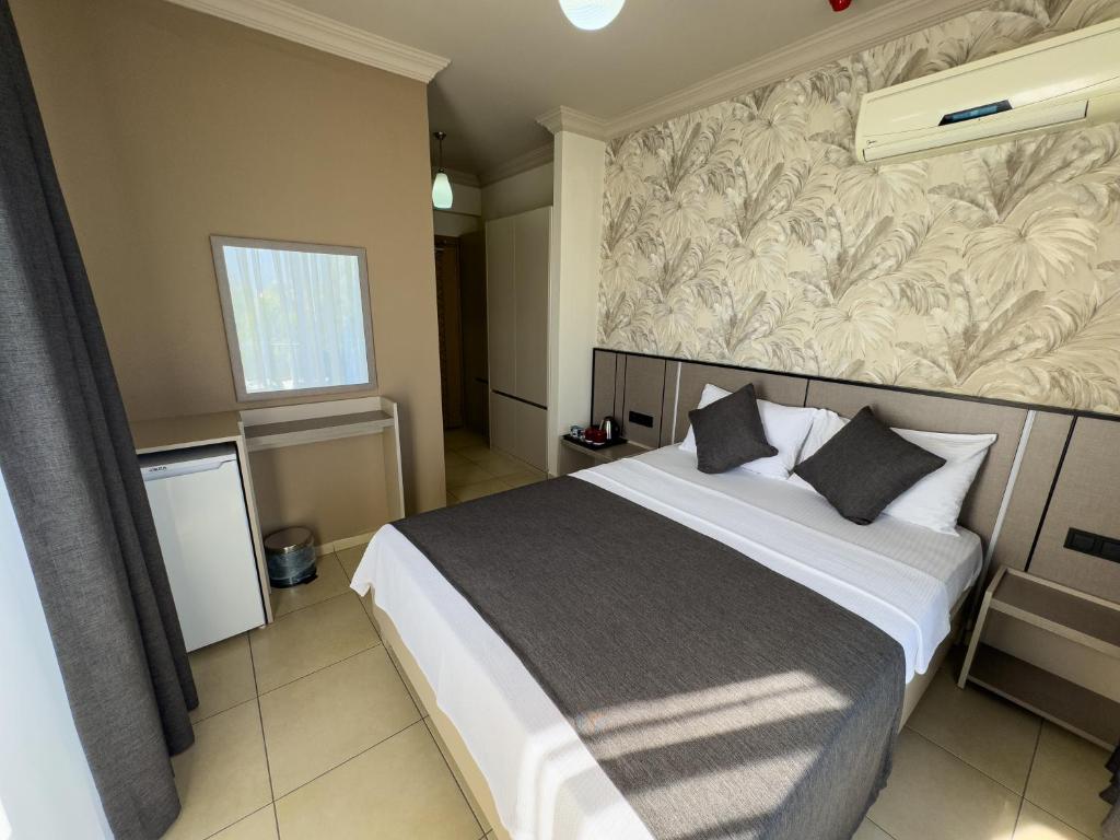 Postel nebo postele na pokoji v ubytování Sardunya Hotel