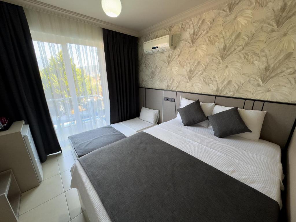 Postel nebo postele na pokoji v ubytování Sardunya Hotel