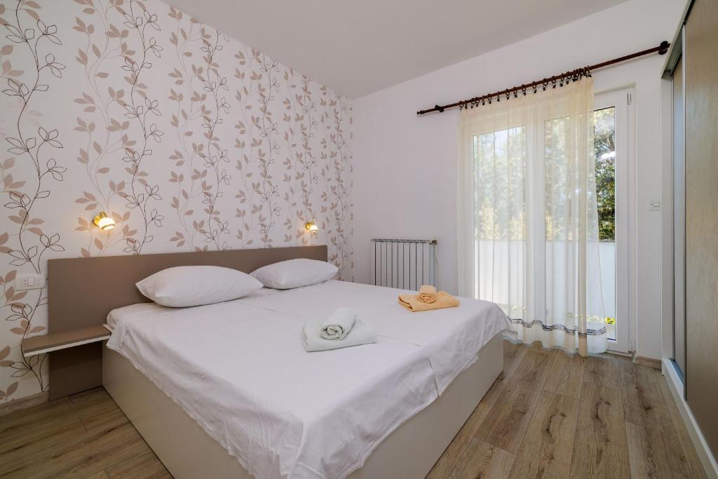 Postel nebo postele na pokoji v ubytování Apartments Marija G