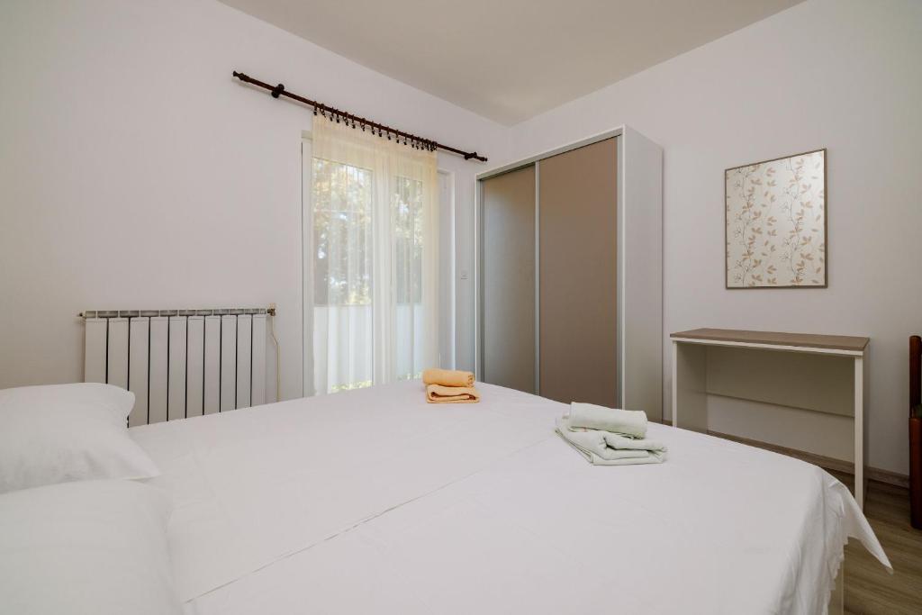 Postel nebo postele na pokoji v ubytování Apartments Marija G