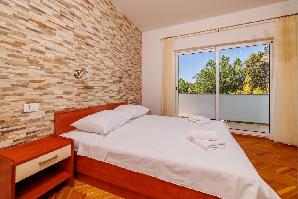 Postel nebo postele na pokoji v ubytování Apartments Marija G