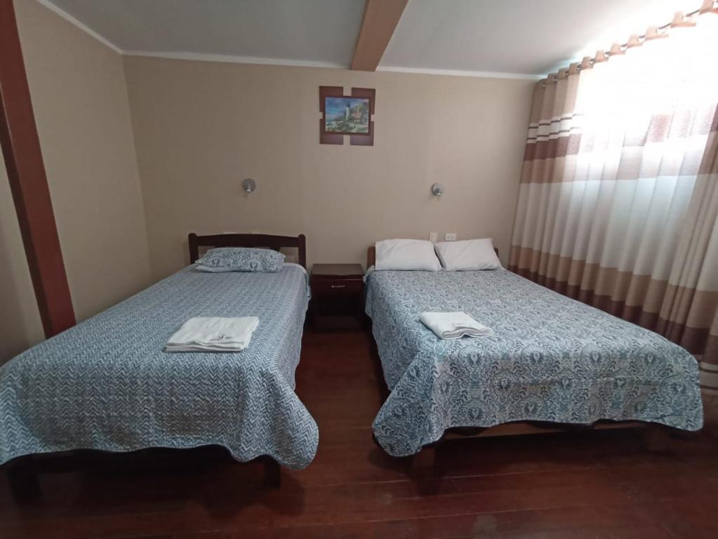A bed or beds in a room at Casa Hospedaje VIRREY