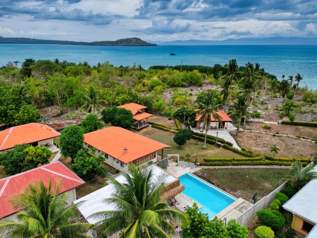 an aerial view of a resort with a swimming pool and the ocean at Villa Alessandra Homestay in Moalboal