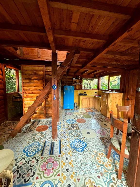 a large room with a kitchen with a table and chairs at Beehouse Mandala in Guarne