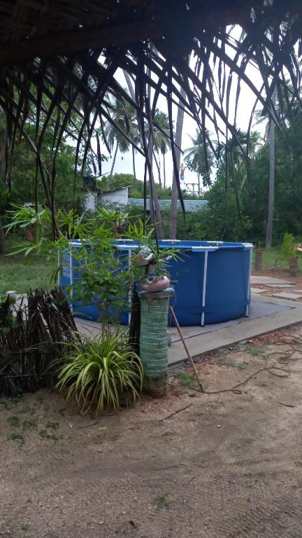 a group of blue dumpsters in a greenhouse at Elena Garden Resort and Restaurant in Trincomalee