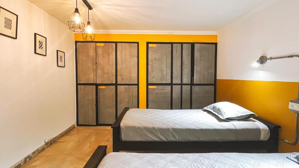 Postel nebo postele na pokoji v ubytování Malaika Hostel Medellín