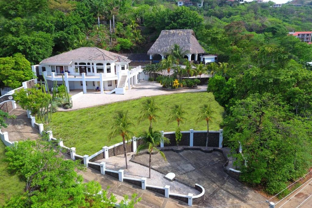 an aerial view of a house with palm trees at Villa Pura Vida - All Inclusive in Ocotal