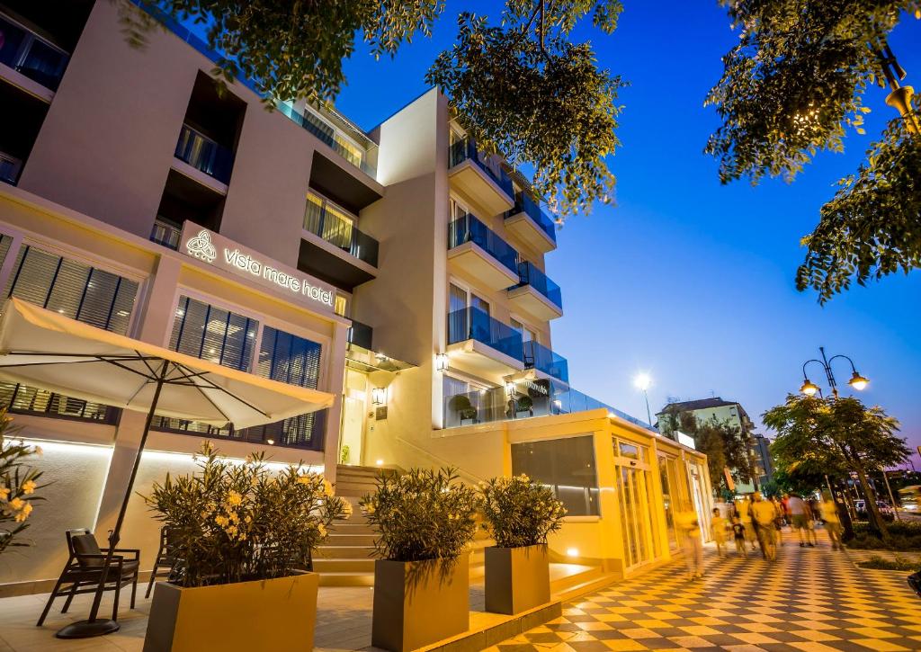 un edificio con una sombrilla delante de él en Hotel Vista Mare & Spa, en Cesenatico