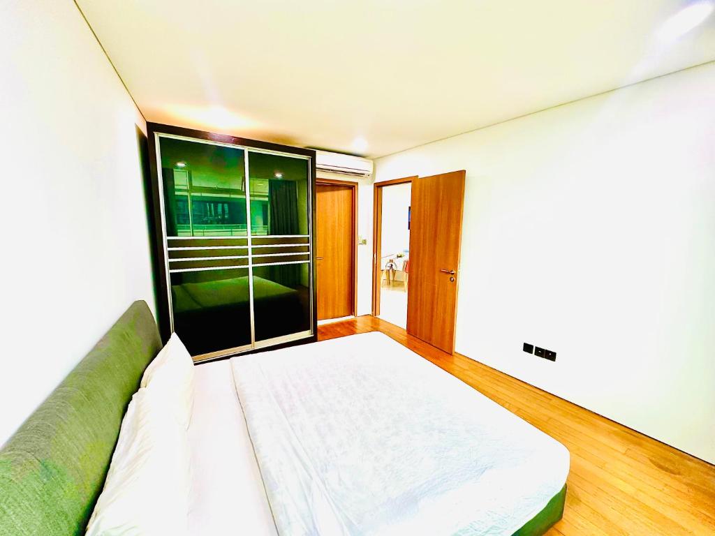 a room with a bed and a large window at Around KLCC area vortex apartment in Kuala Lumpur