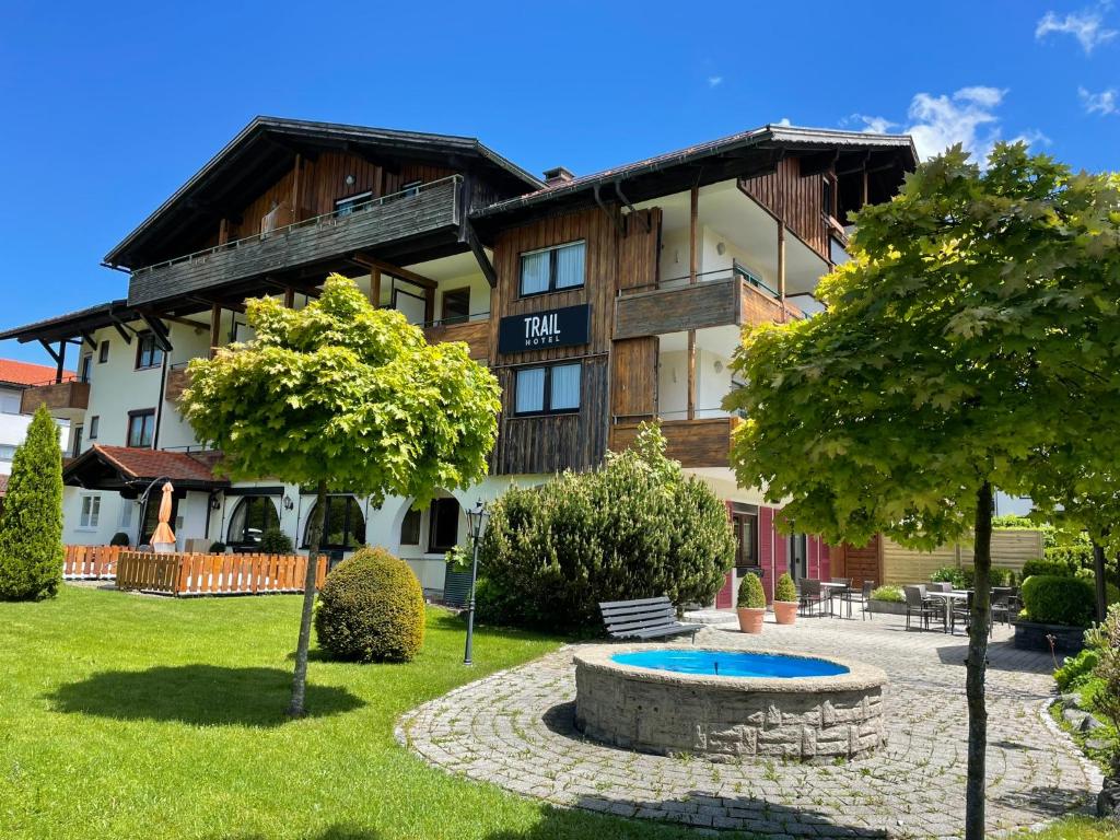 a building with a fountain in front of it at Trail Hotel Oberstaufen in Oberstaufen