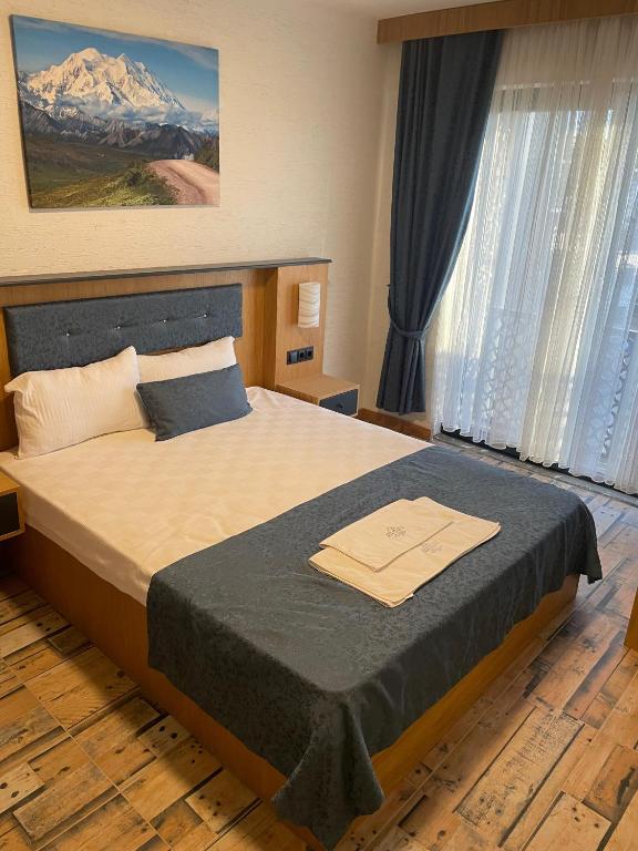 Postel nebo postele na pokoji v ubytování Grand Rimedya Burhaniye