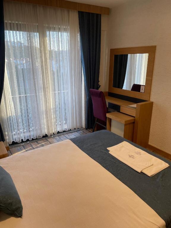 Postel nebo postele na pokoji v ubytování Grand Rimedya Burhaniye