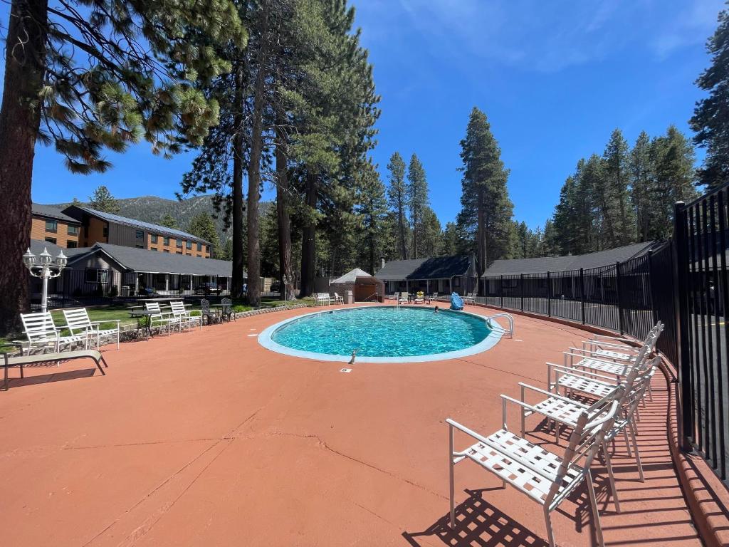 a large swimming pool with chairs around it at Tahoe Hacienda Inn in South Lake Tahoe