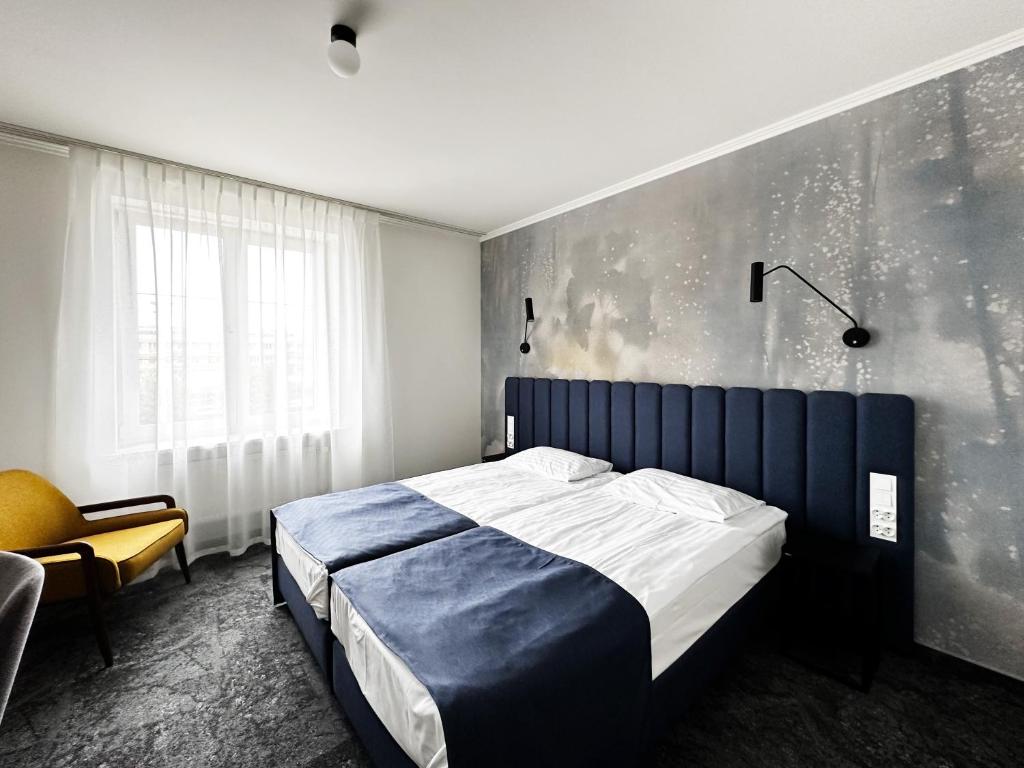 Posteľ alebo postele v izbe v ubytovaní Hotel Szydłowski