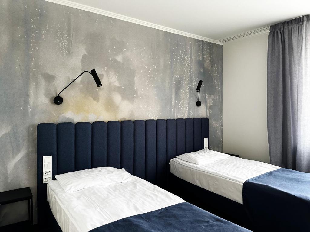Posteľ alebo postele v izbe v ubytovaní Hotel Szydłowski