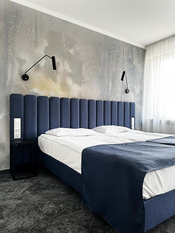 Posteľ alebo postele v izbe v ubytovaní Hotel Szydłowski