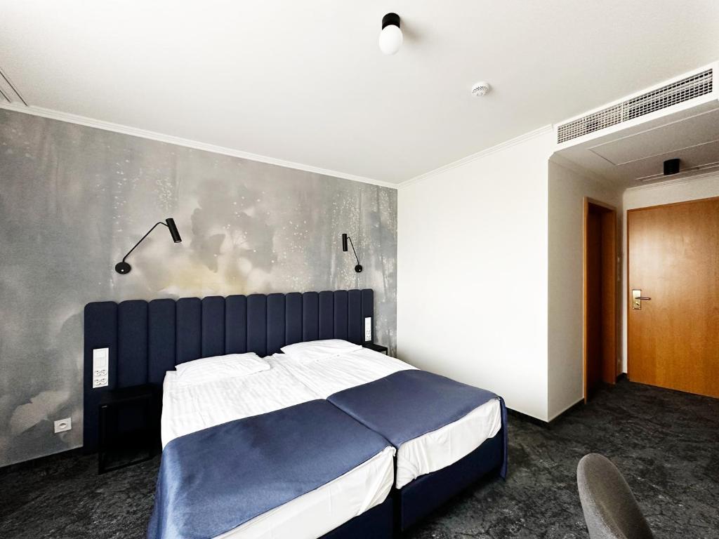 Posteľ alebo postele v izbe v ubytovaní Hotel Szydłowski