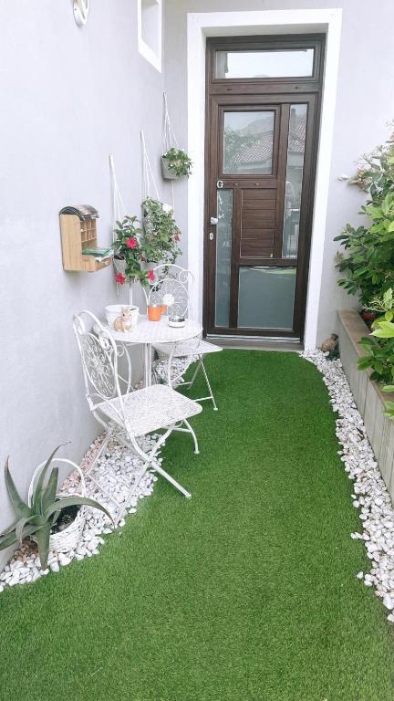 a patio with green grass and a table and chairs at Casa Vacanze MURANUM - B&B in Morano Calabro