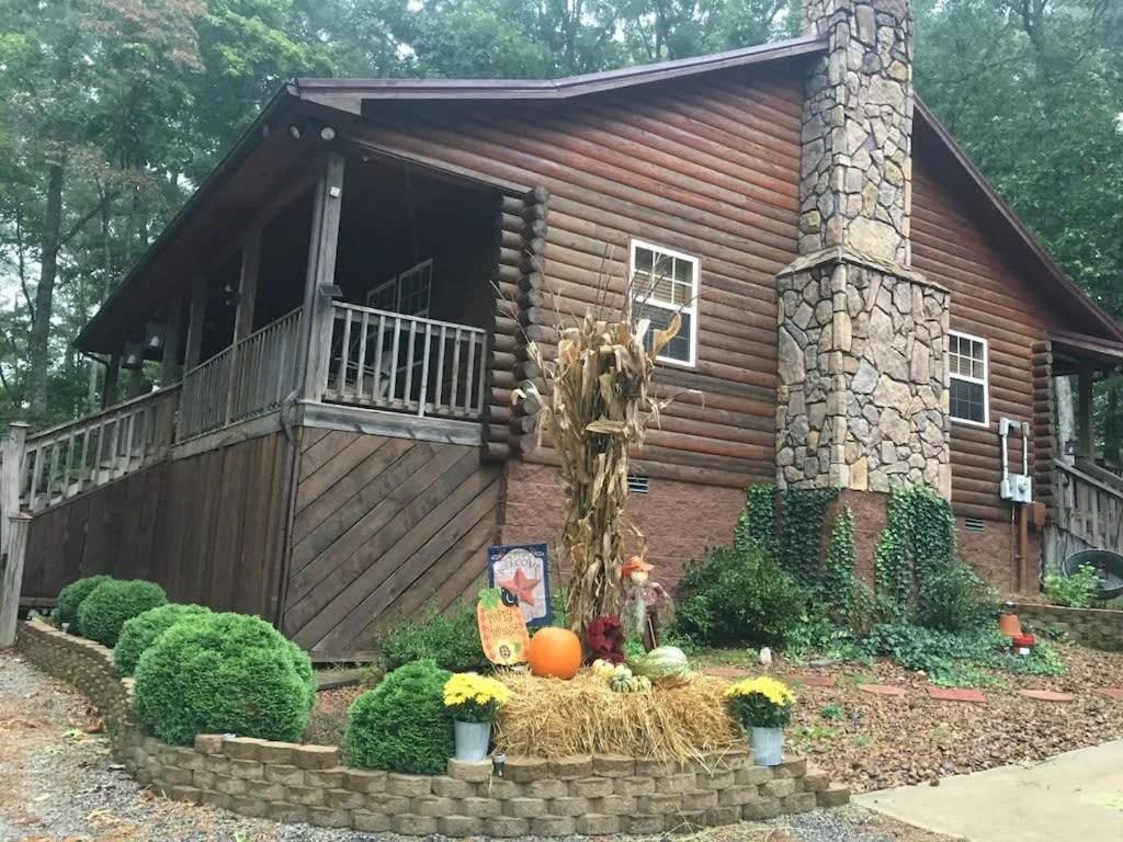 a log cabin with a porch and pumpkins in front of it at TN State Parks Open! Hikes, Waterfalls, Firepits! in Spencer