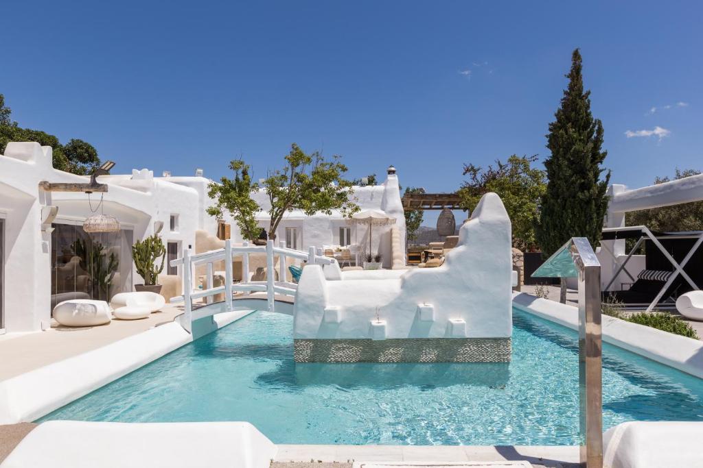 a pool at a resort with a slide at Kallos Villas & Suites in Naxos Chora