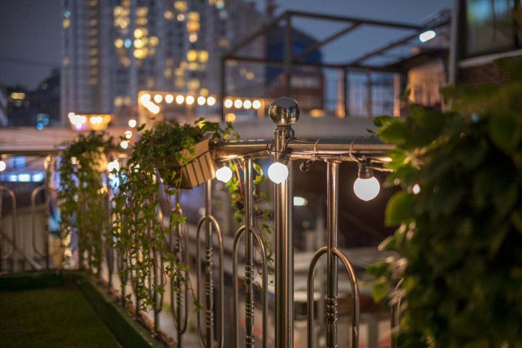 a fence with plants and lights on a city street at Stay Hannam Foreigner only in Seoul