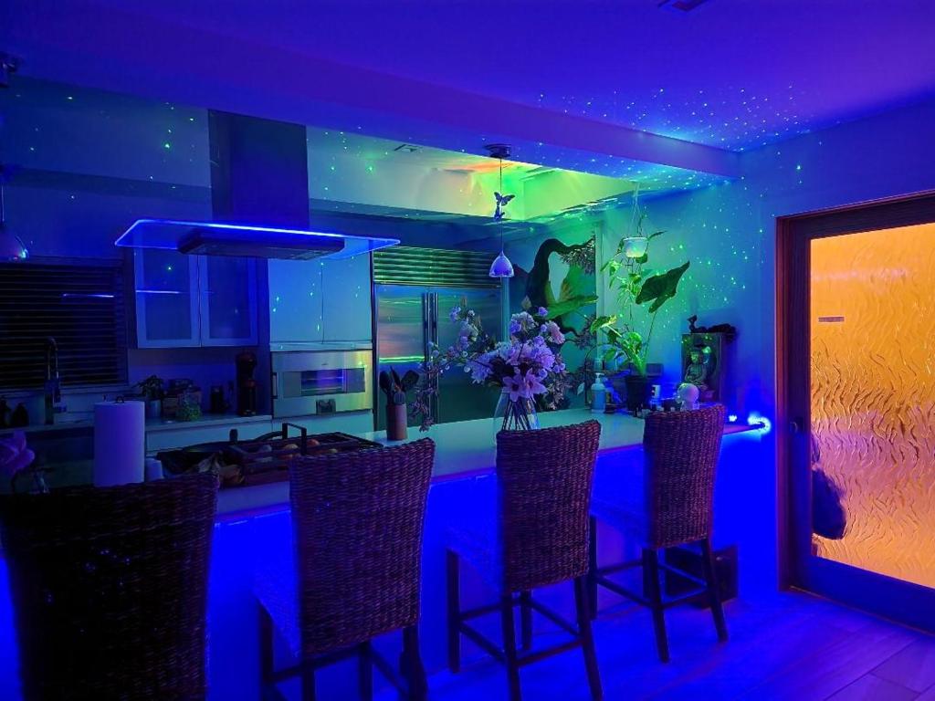a kitchen with a bar with blue lighting at Heaven's Best Kept Secret 4 Min From The Sea in Pacific Palisades