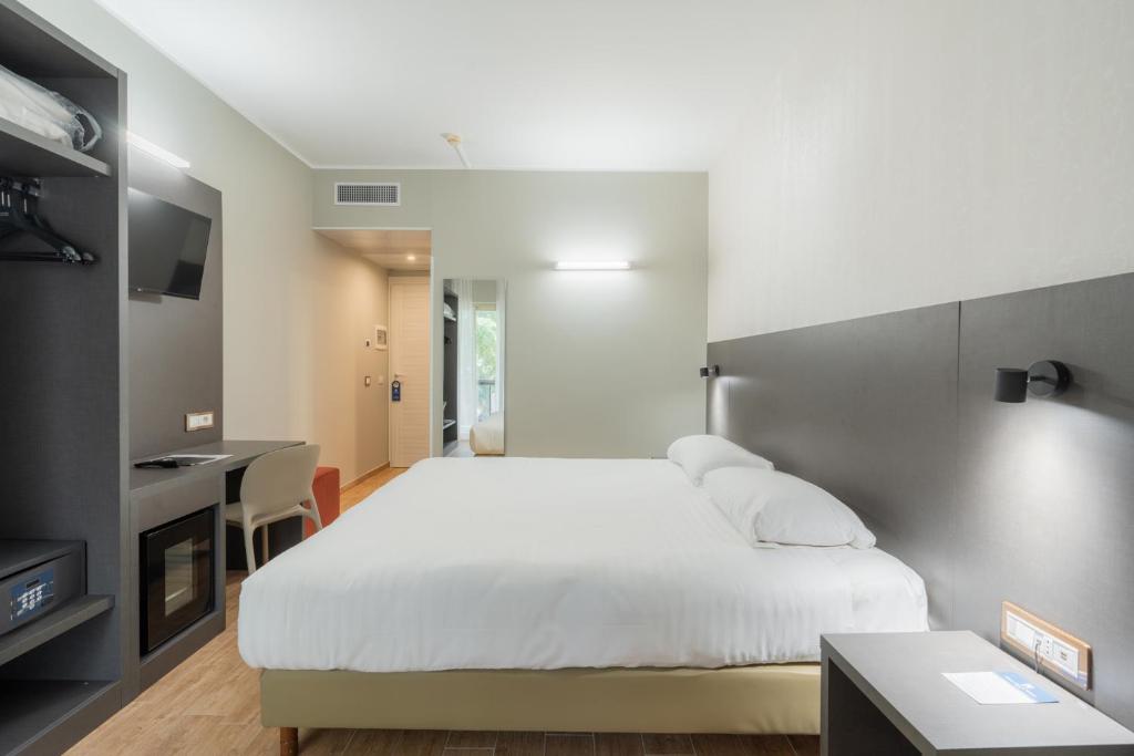 Postel nebo postele na pokoji v ubytování Hotel Pineta Palace