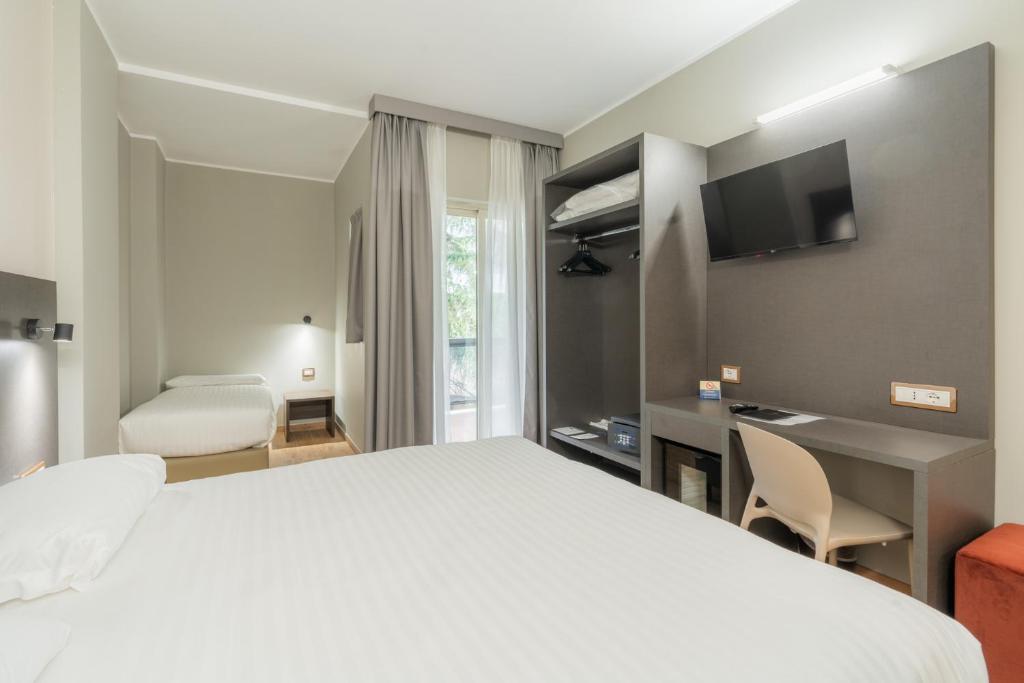 Postel nebo postele na pokoji v ubytování Hotel Pineta Palace