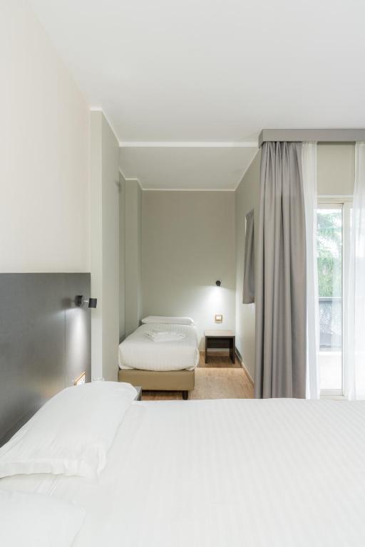 Postel nebo postele na pokoji v ubytování Hotel Pineta Palace