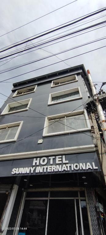 a building with a sign that reads hotel summaryinformation at hotel sunny international in Jammu